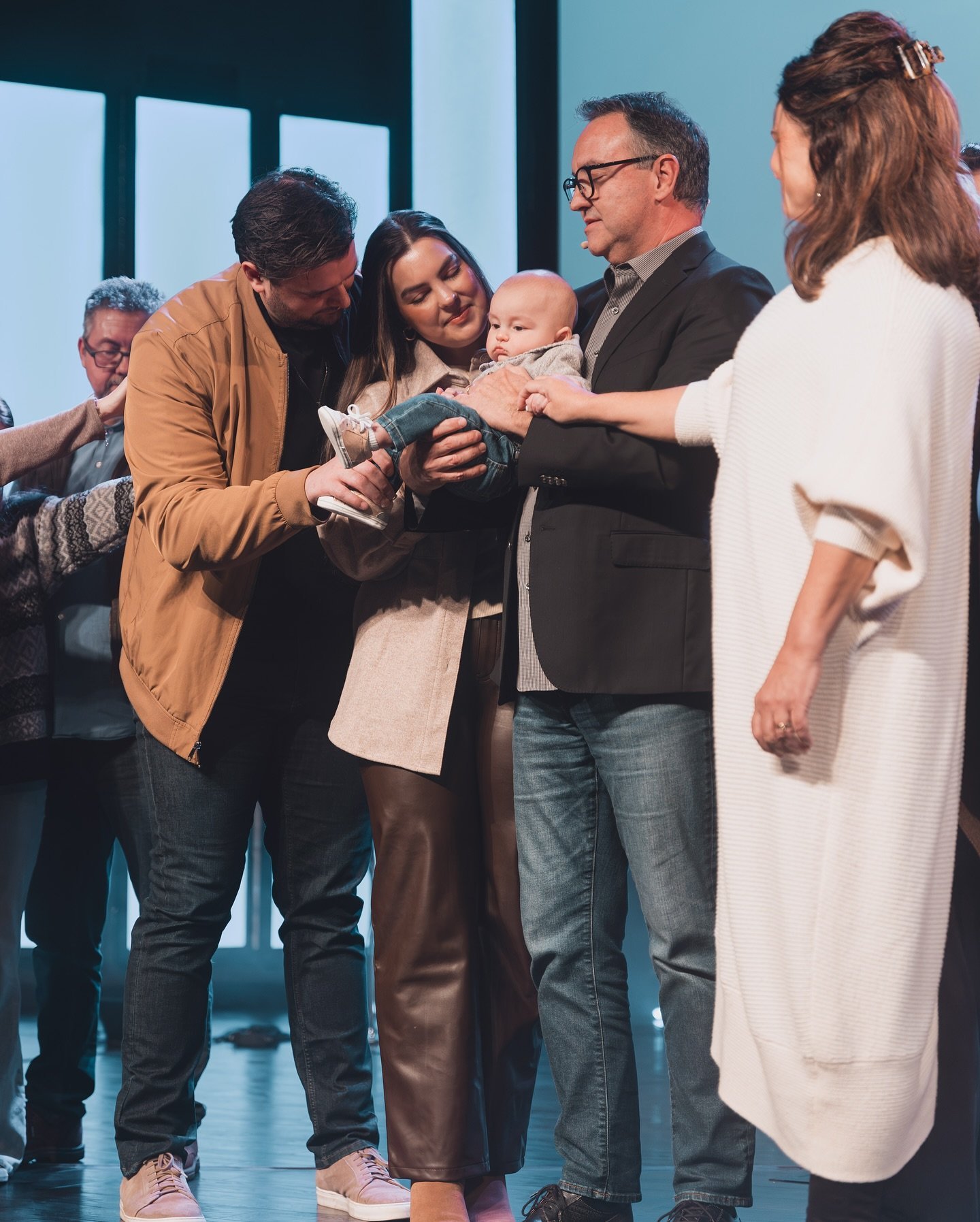 A family dedicating their baby on stage at Stone Edge Church